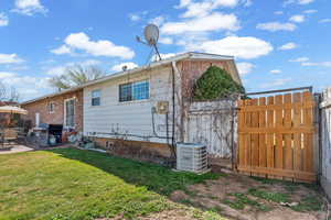 Back of house featuring a patio area and brick siding
