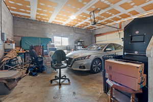 Garage featuring concrete block wall