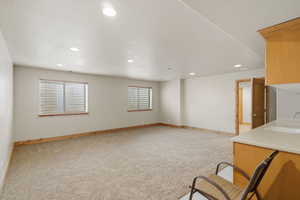 Unfurnished living room with light carpet and recessed lighting