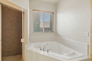 Full bath featuring a shower stall and a jetted tub