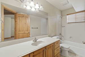 Bathroom featuring vanity, shower / bath combination, and light tile patterned floors