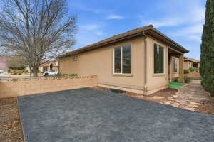 View of property exterior with stucco siding and a patio area