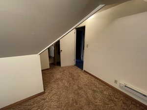 Bonus room with baseboard heating, carpet, and lofted ceiling