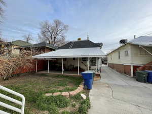 Rear view of house featuring a metal roof
