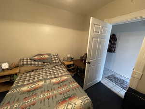 Bedroom with dark tile patterned flooring