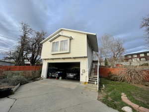 View of home's exterior featuring an attached garage and concrete driveway