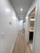 Hall featuring light wood-style floors and recessed lighting