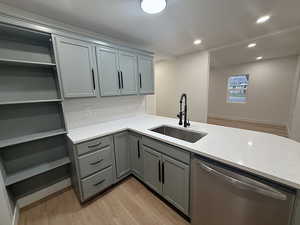 Kitchen featuring light wood-type flooring, dishwasher, gray cabinetry, and recessed lighting