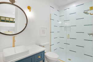 Bathroom featuring vanity, a shower stall, and recessed lighting