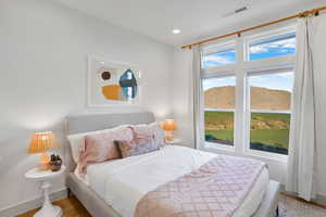 Bedroom with wood finished floors and recessed lighting