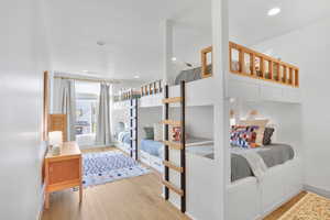 Bedroom with light wood finished floors and recessed lighting