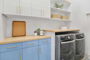 Laundry area featuring cabinet space and washing machine and clothes dryer