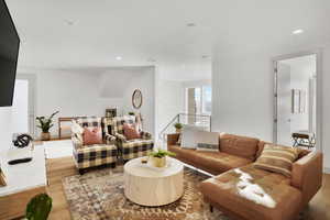 Living area featuring light wood finished floors and recessed lighting