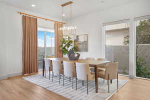 Dining space featuring suspended lighting, plenty of natural light, and light wood finished floors
