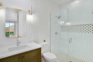 Bathroom featuring a stall shower and vanity