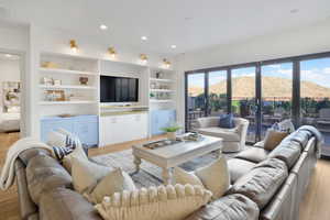Living room with light wood finished floors and recessed lighting