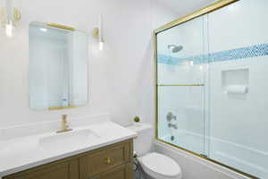 Full bathroom with vanity and combined bath / shower with glass door