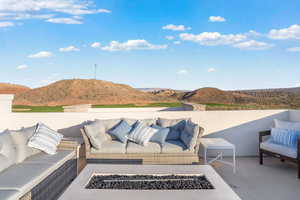 View of patio / terrace with a mountain view and an outdoor living space with a fire pit