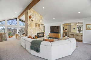 Carpeted living area featuring a fireplace and recessed lighting
