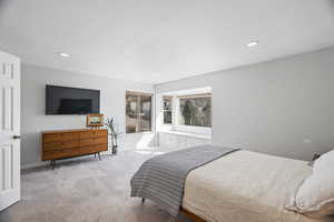Bedroom featuring light carpet and recessed lighting