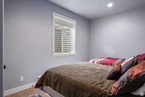 Carpeted bedroom featuring baseboards and recessed lighting