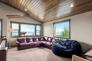 Living room featuring carpet flooring, a vaulted wood ceiling, and recessed lighting