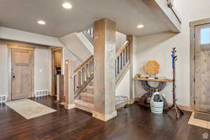 Foyer featuring dark wood finished floors, recessed lighting, and a textured ceiling