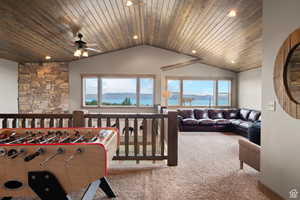 Carpeted living room with healthy amount of natural light, a ceiling fan, recessed lighting, and wood ceiling