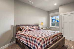 Carpeted bedroom featuring baseboards