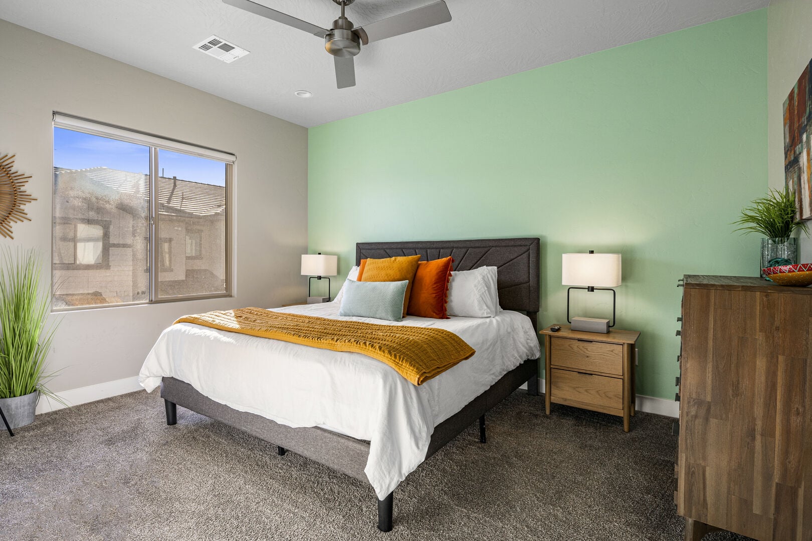 Carpeted bedroom with baseboards and ceiling fan