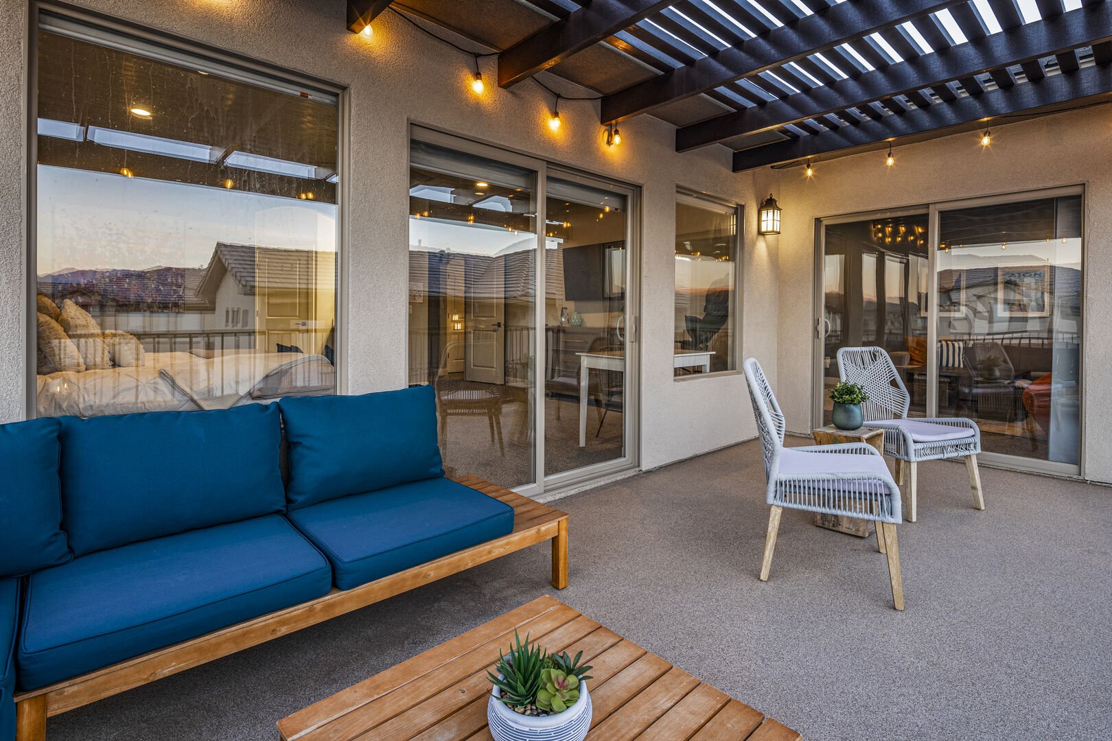 Wooden deck with a pergola, outdoor furniture, and a patio