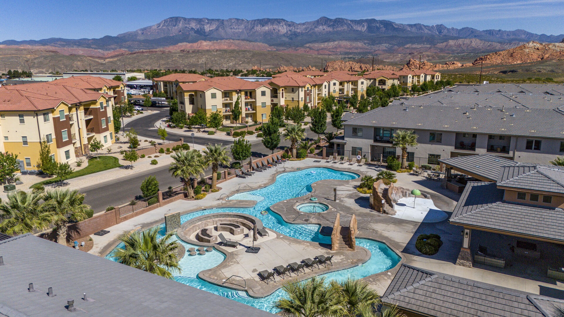 Aerial view of residential area with mountains and a pool area