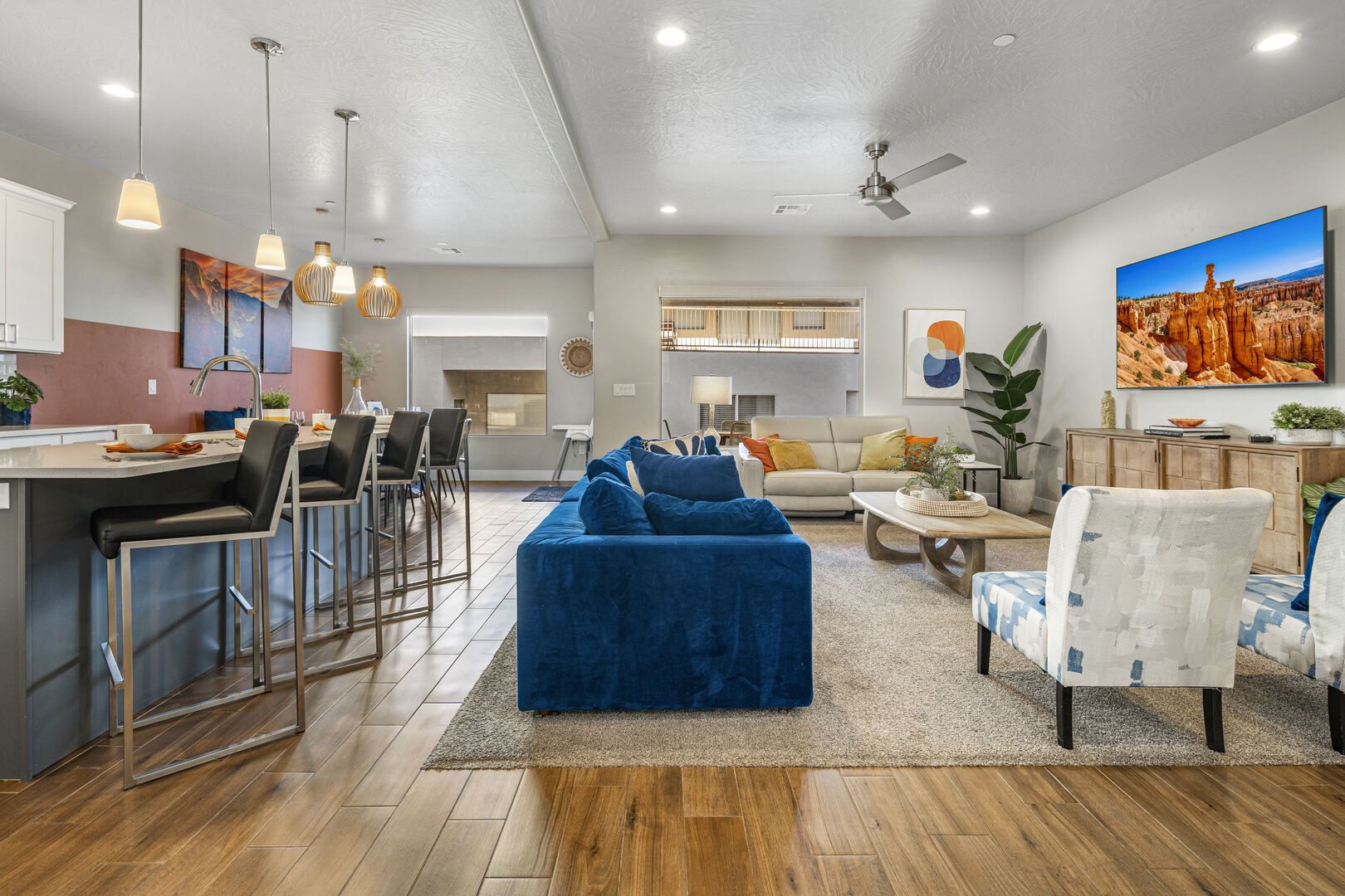 Living area featuring light wood-style floors, a ceiling fan, a textured ceiling, and recessed lighting