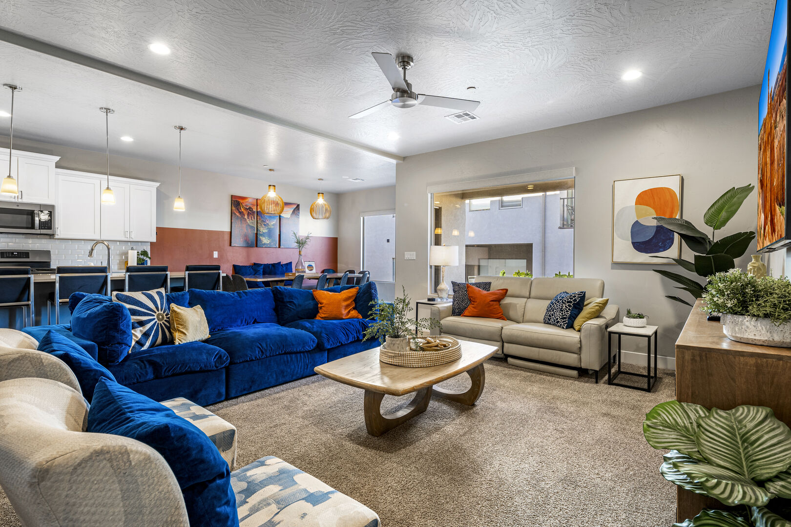 Living area featuring ceiling fan, a textured ceiling, carpet, and recessed lighting