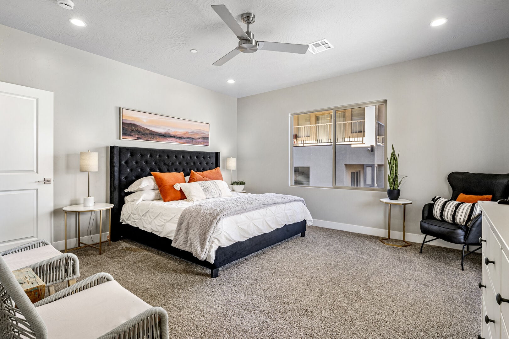 Carpeted bedroom with a ceiling fan and recessed lighting