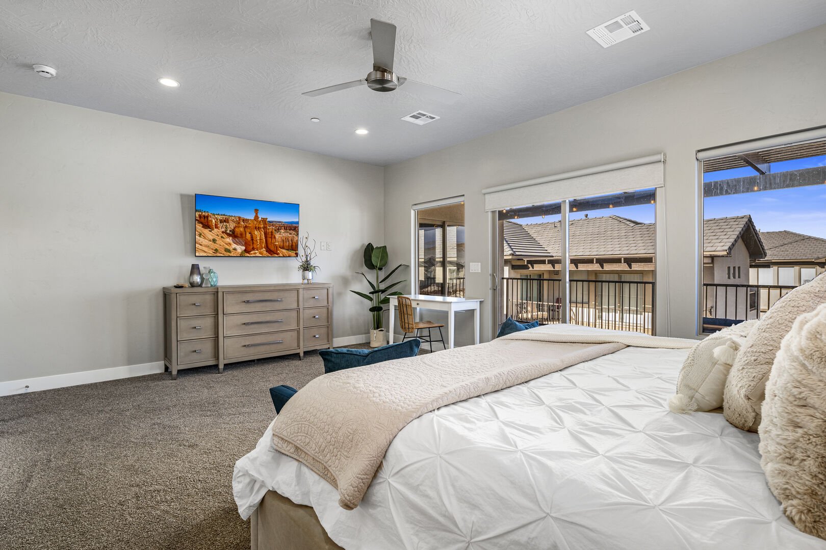Carpeted bedroom featuring access to outside and a ceiling fan