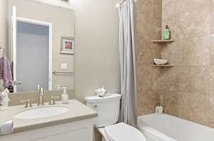 Bathroom featuring vanity and shower / tub combo with curtain