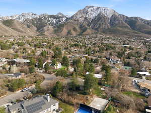 Aerial overview of property's location featuring a mountain backdrop and nearby suburban area