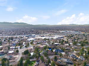 Aerial perspective of suburban area featuring a mountain backdrop