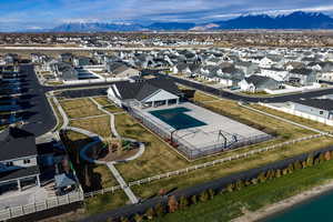 Aerial perspective of clubhouse, pool,a walking path, and one of several neighborhood parks