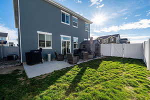 Rear view of house featuring a gate, a fenced backyard, a patio area, and stucco siding