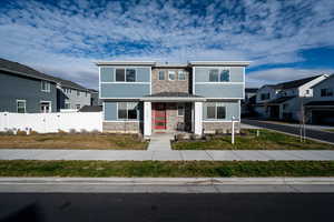 View of front of property with stone siding and a residential view