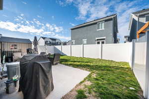 Fenced backyard featuring a patio and a residential view