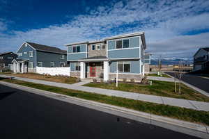 View of front of home featuring stone siding and a residential view