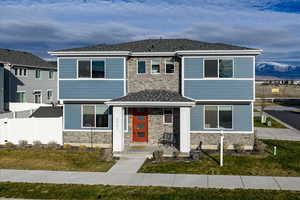 View of front of house featuring stone siding and a mountain view