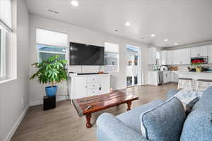 Living room featuring light wood-style floors and recessed lighting