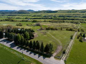 Expansive green acreage featuring rolling hills and distant mountains