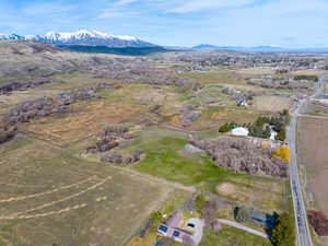 Aerial view of property and surrounding area with rural landscape and a mountainous background