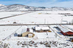 Snowy aerial view featuring a mountain view