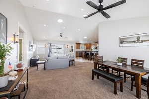 Dining area featuring ceiling fan, light colored carpet, recessed lighting, and lofted ceiling